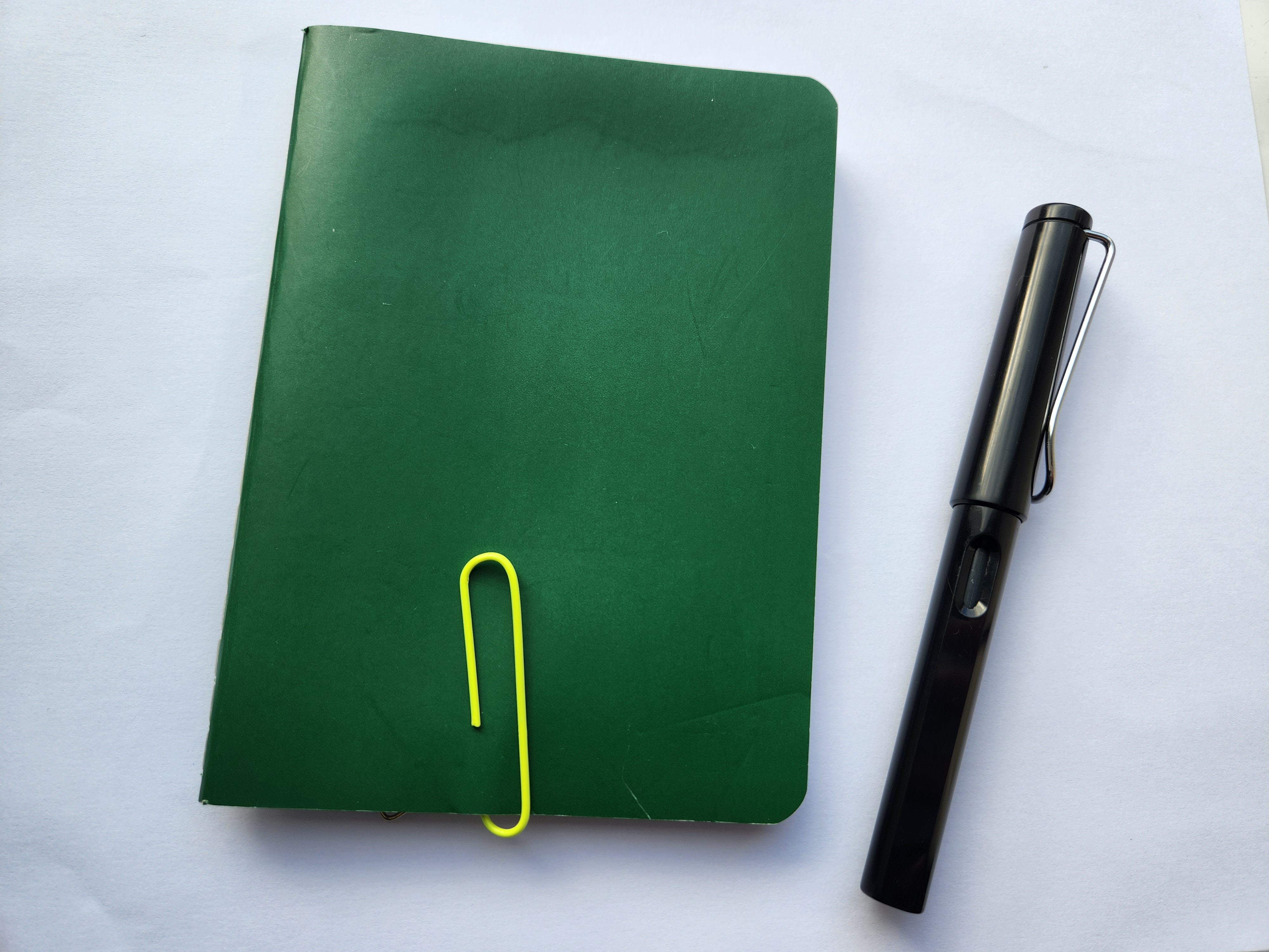 notebook with lamy safari next to it