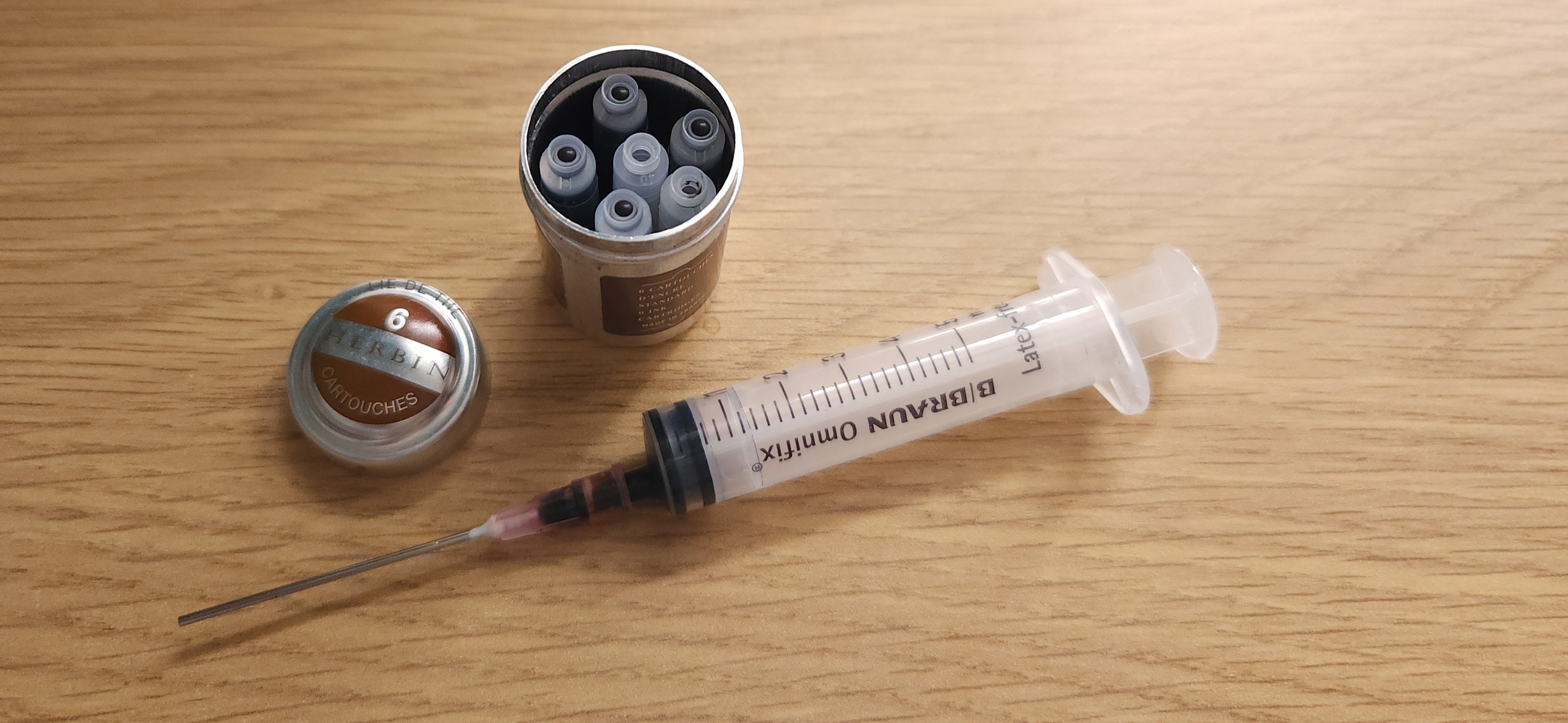 The canister, plus the blunt syringe I use to get ink out of the cartridges so I can put it in incompatible pens.